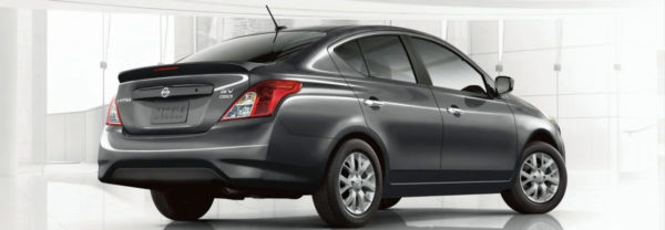 Gray 2019 Nissan Versa parked in a showroom.